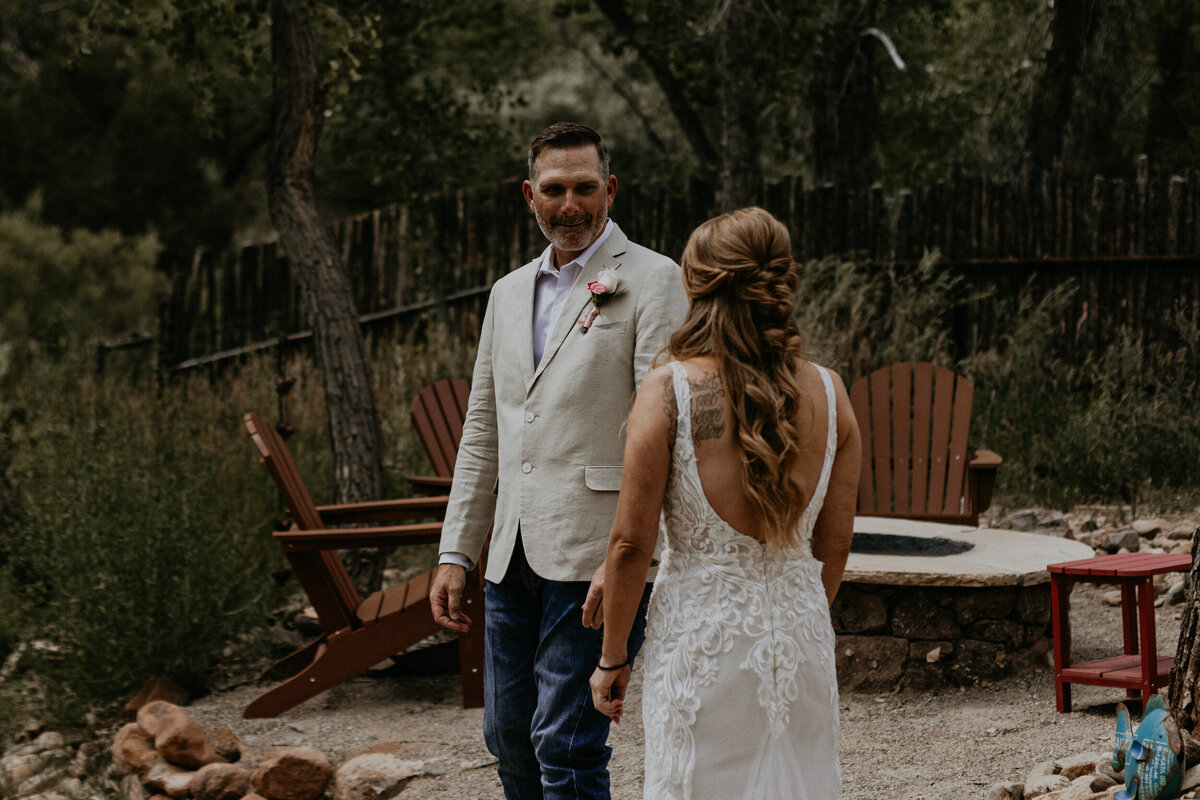 groom seeing his bride for the first time during their first look