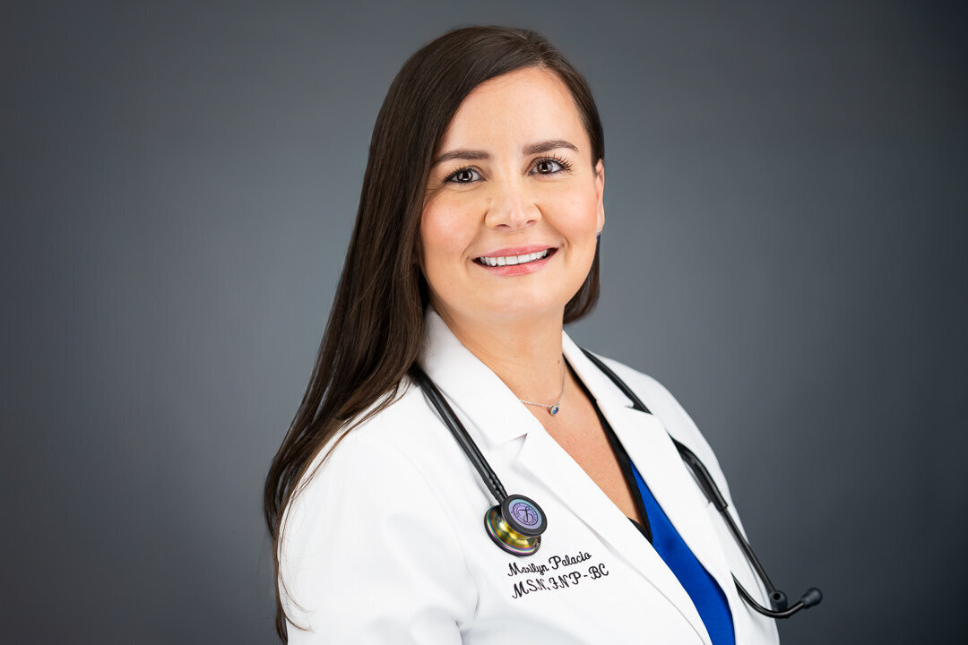 Professional headshot of smiling female doctor in white coat – Bergen County NJ medical headshot by Alex Kaplan Photography