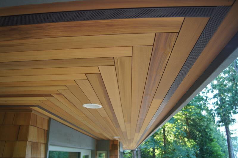 Outdoor patio area with cedar soffits and pot lights.