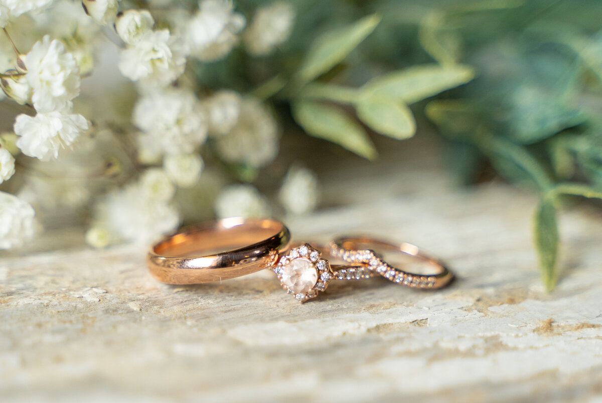 Jess and Alex Cox' rose gold wedding rings at their wedding at Peacock Ridge in Lawrence, Ohio.