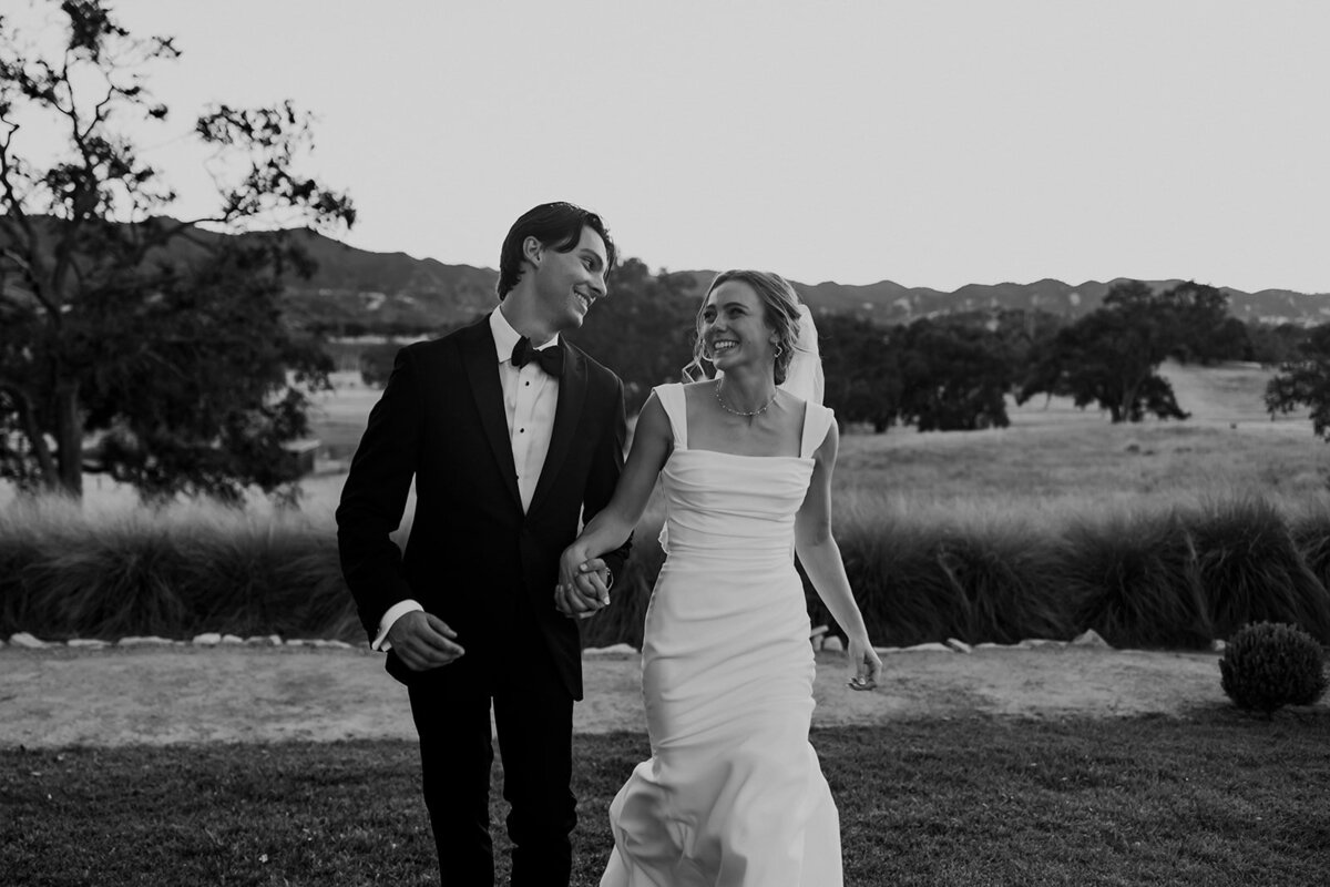 bride and groom walking together smiling
