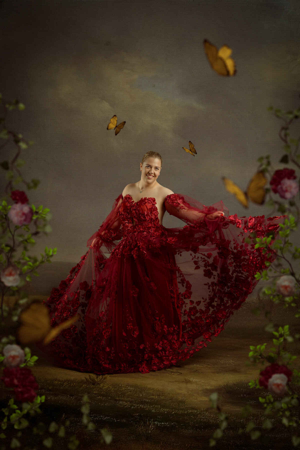 Studio Ace Photography Zaltbommel fine art portret van dame in handgemaakte rode jurk met bloemen dansend in een schilderachtige omgeving
