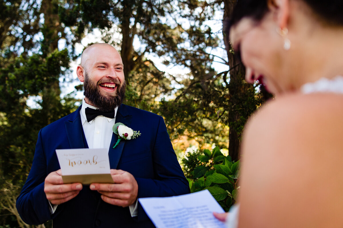 One of the top wedding photos of 2020. Taken by Adore Wedding Photography- Toledo, Ohio Wedding Photographers. This photo is of a bride and grooms first look exchanging letters and laughing at the Henry Ford House in Detroit Michigan