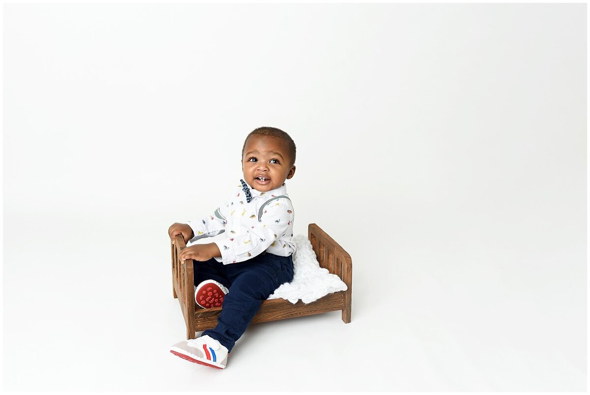 A toddler's studio portrait, capturing their playful and mischievous nature in a controlled environment.