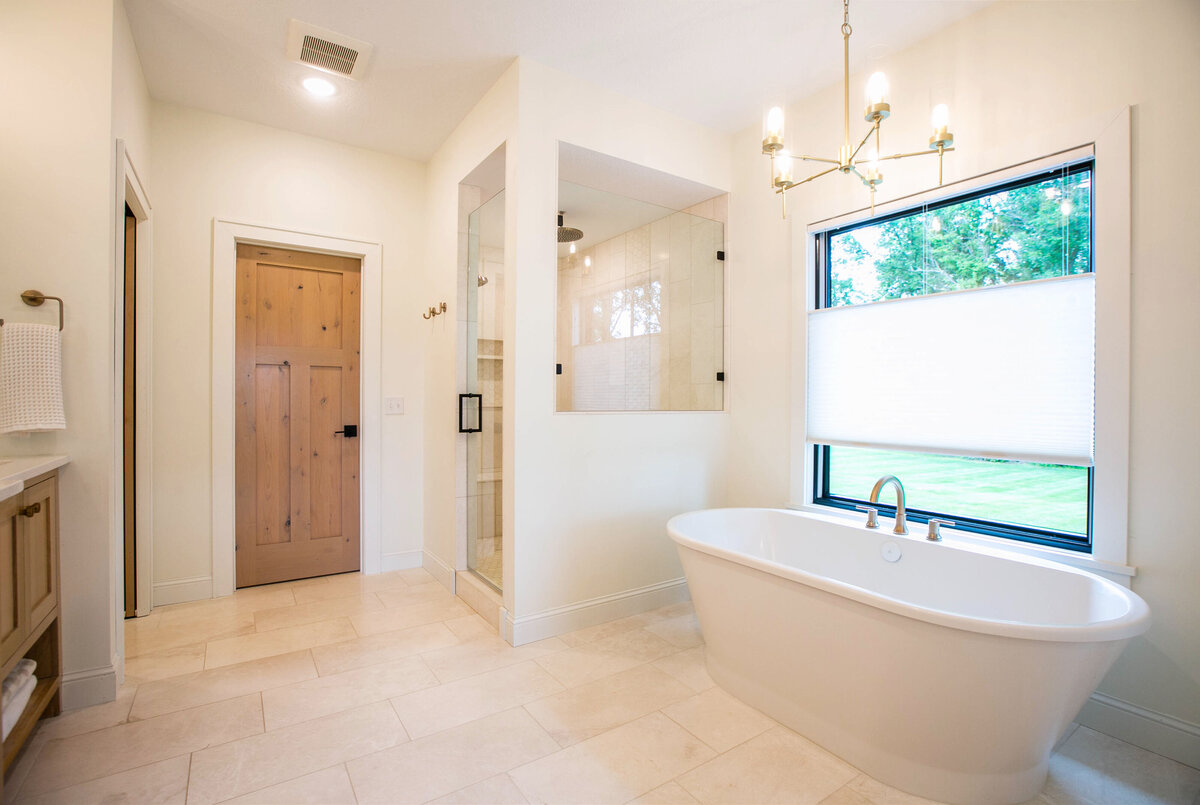 Custom bathroom with soaking tub, double vanity, and walk-in shower in Otsego custom home