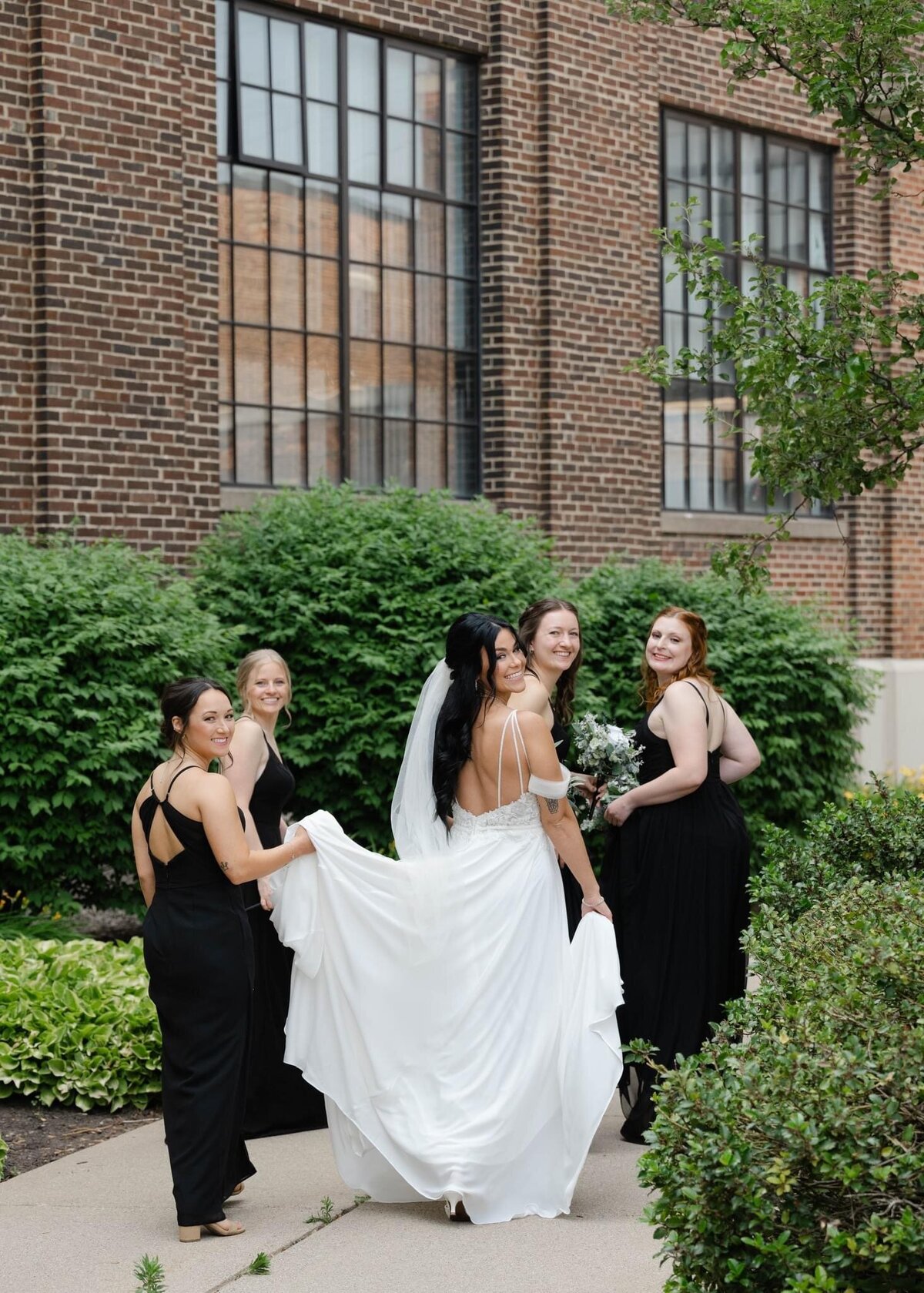 bride and bridesmaids walking at a wedding in Grand Rapids