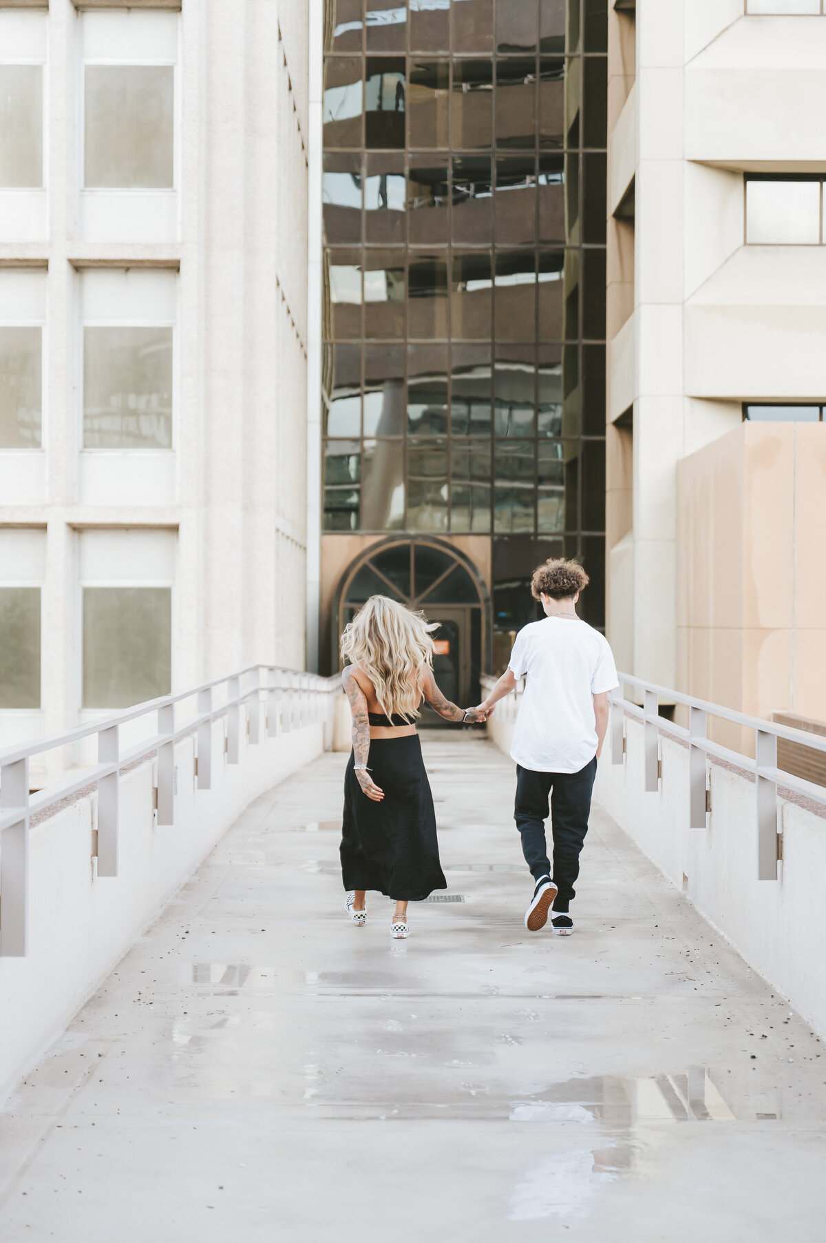 mother and son walking between two buildings in downtown Albuquerque.
