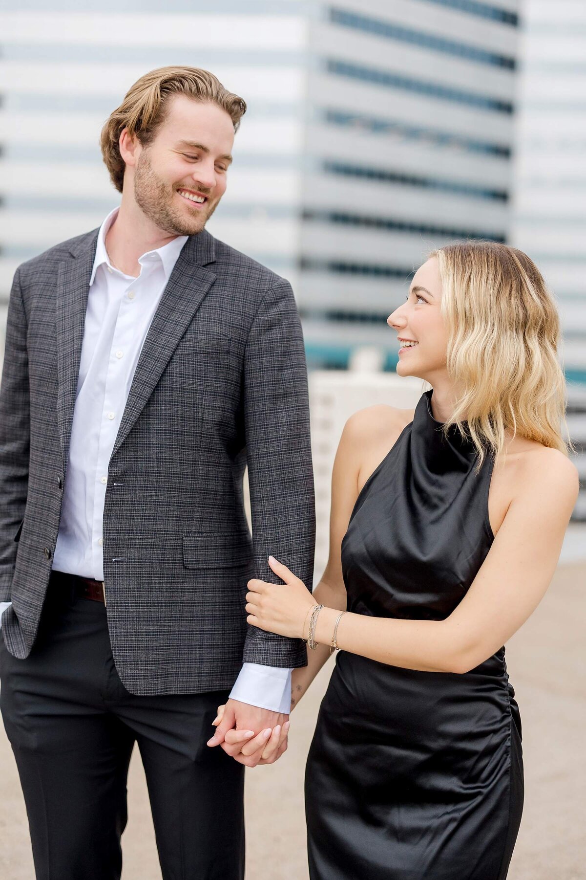 A romantic Minneapolis engagement session showcases a loving couple sharing a passionate kiss in front of a vibrant mural, with the city's urban charm enhancing their intimate moment