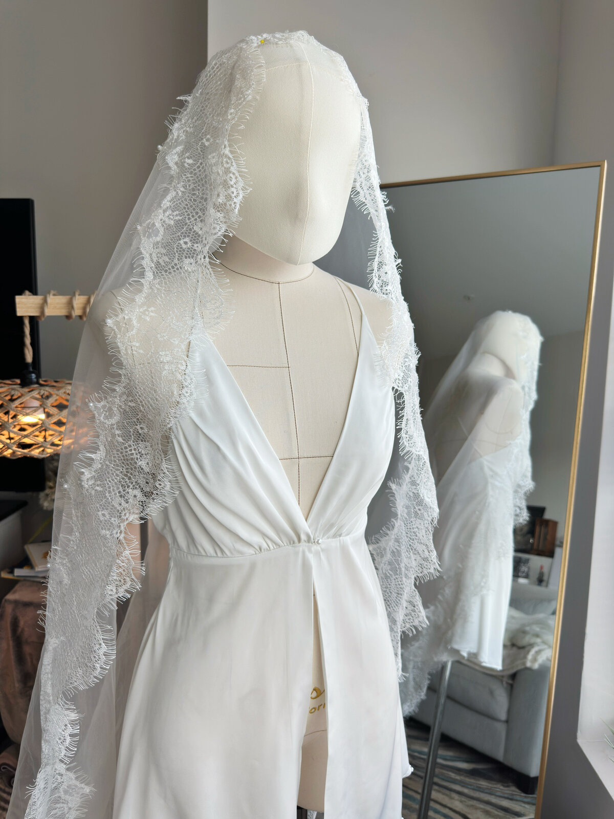 Close-up of scalloped lace edge on ivory mantilla wedding veil