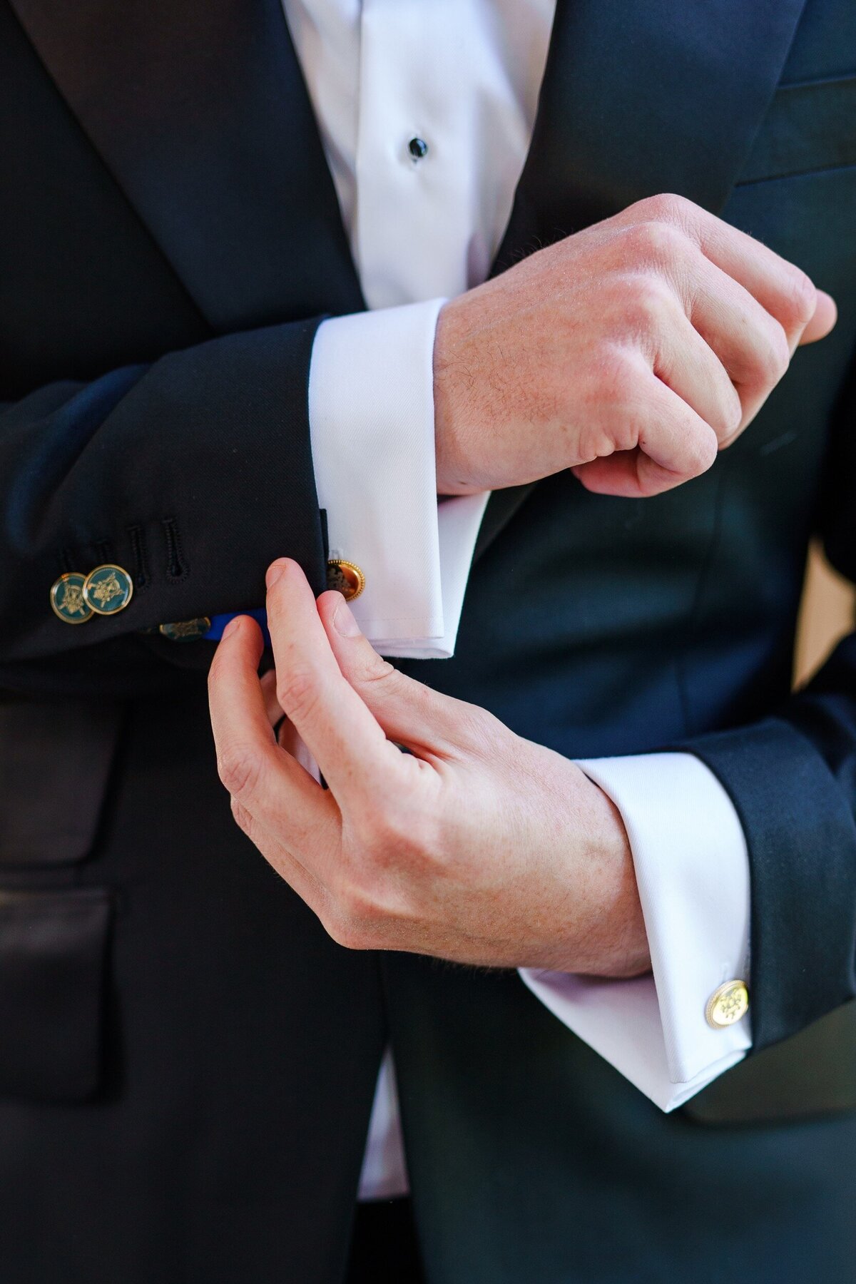 A closeup photo of a groom's custom cufflinks at his wedding in Raleigh, NC.