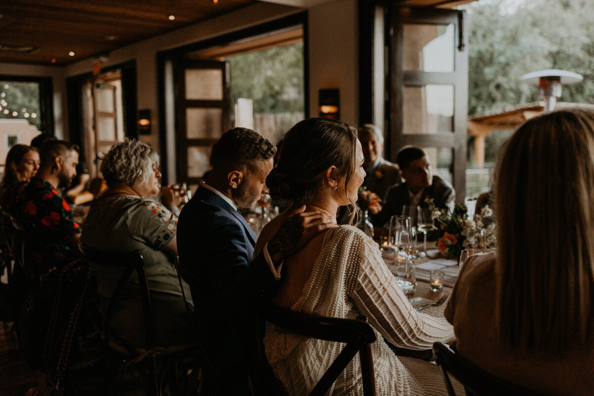 moody shot of speeches at a newlyweds intimate wedding reception dinner