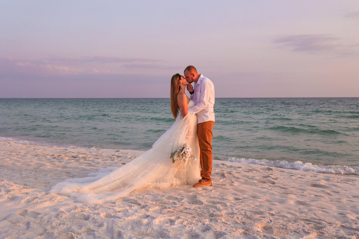 bride and groom kissing on Panama City Beach after elopement by Panama City Beach Florida elopement photographer Amanda Richardson Photography