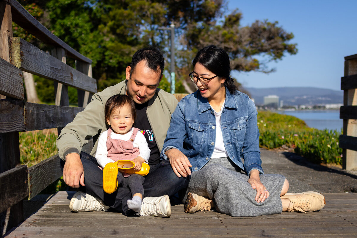 family of three laughing from a Bay Area family surrounded by blooming flowers – Bay Area Family Portfolio - Ellobelle Photography