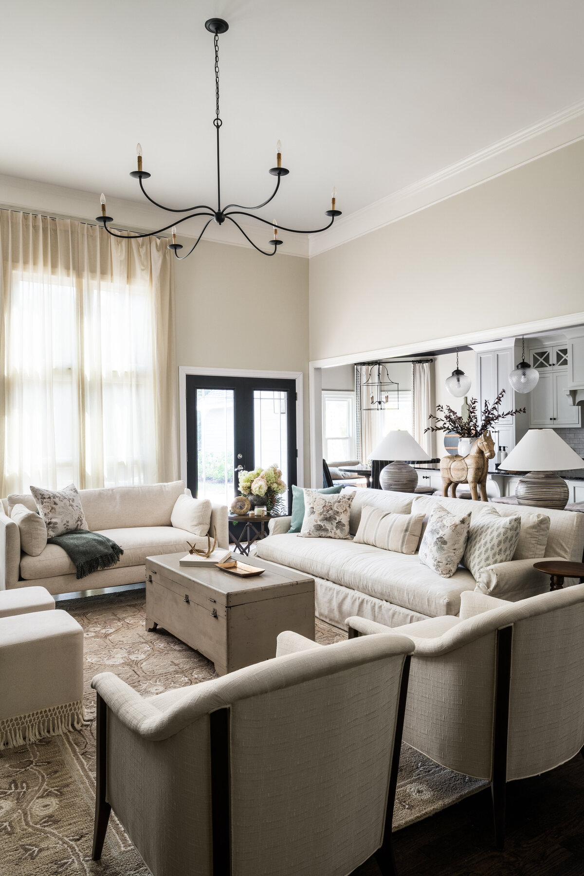 Elegant living room in Concord, NC, with neutral tones, cozy seating, and natural light.