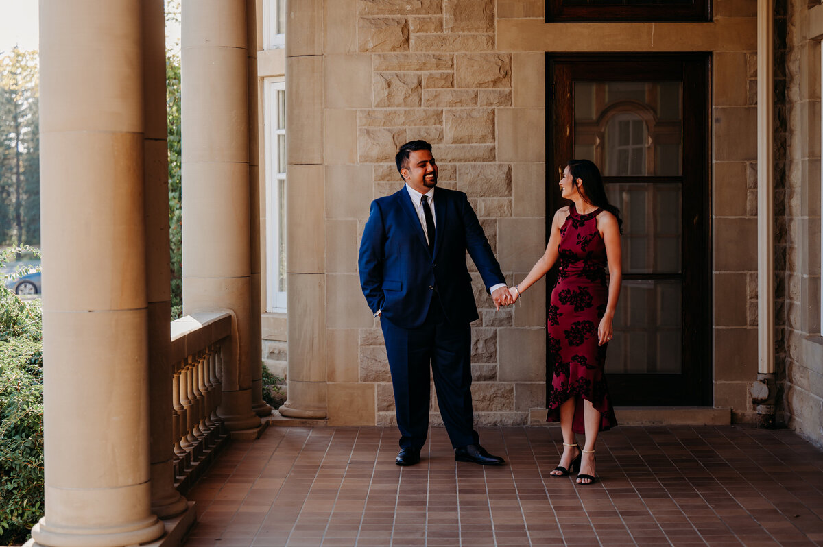 couple holding hands on the balcony of Government House in Edmonton