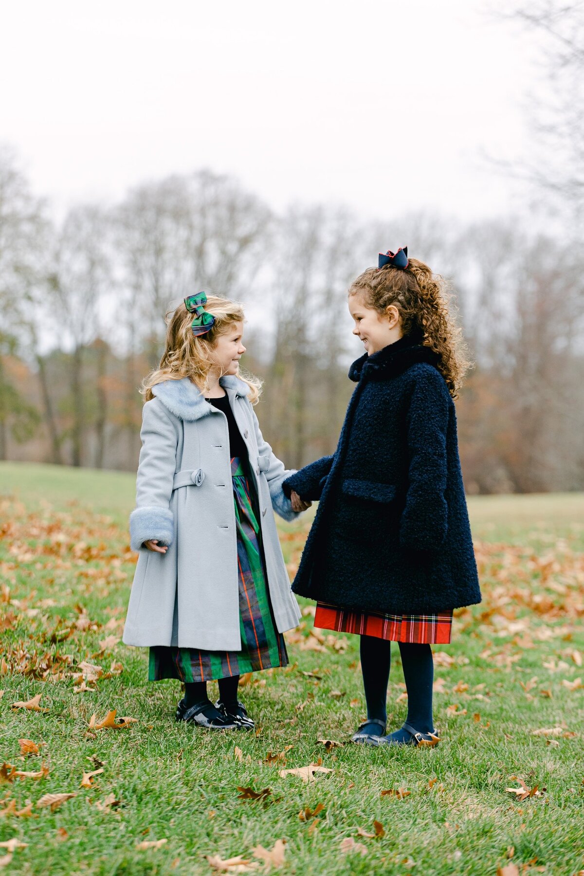 Sisters in holiday coats and dresses