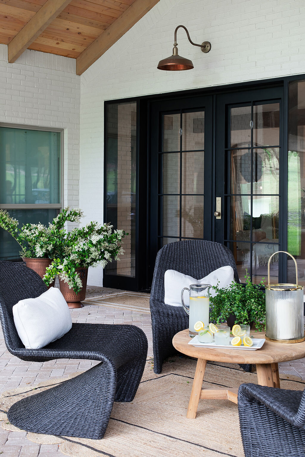 unique modern black rattan outdoor seating with black french doors