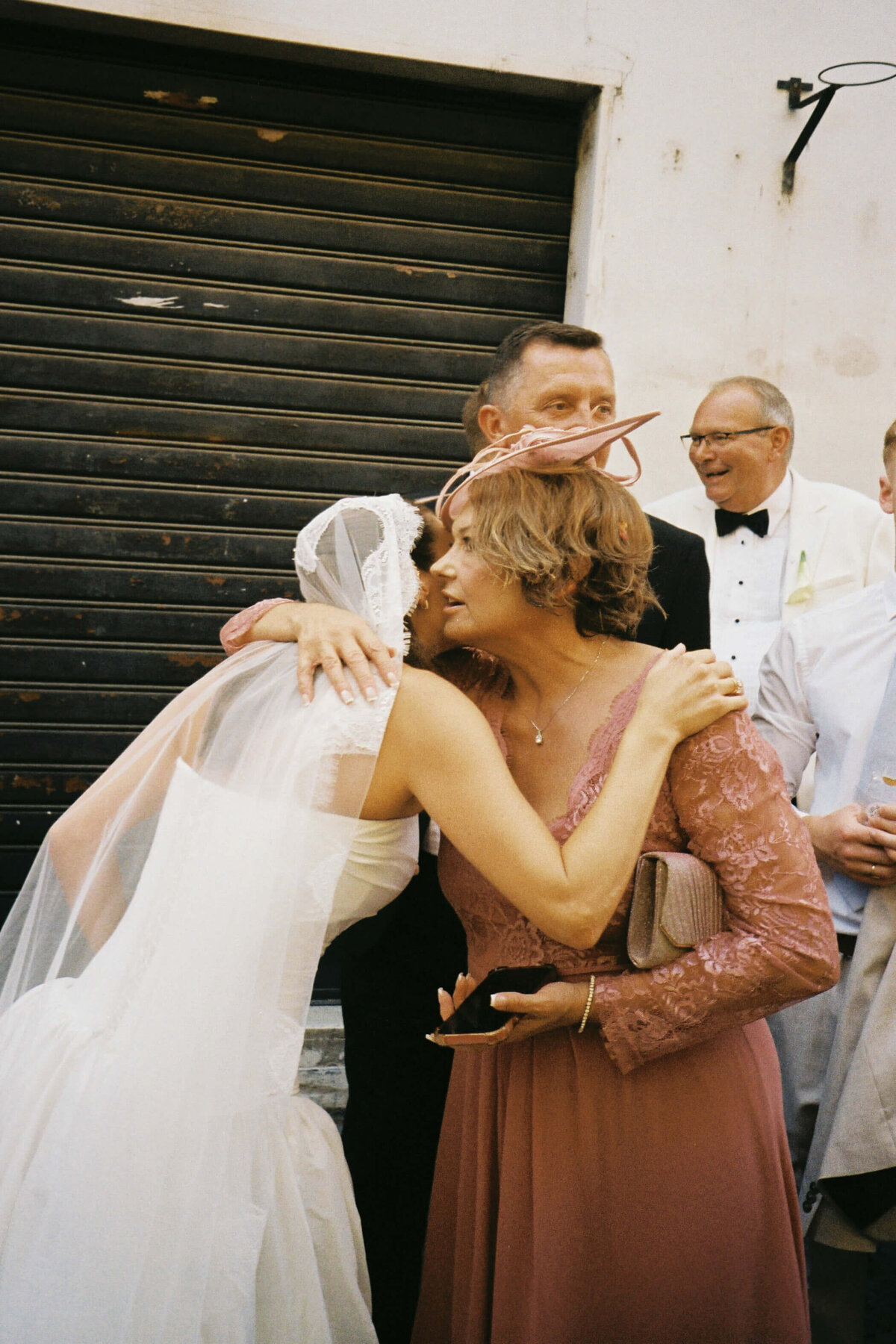 Guests congratulating bride and groom in lively post-ceremony moment

