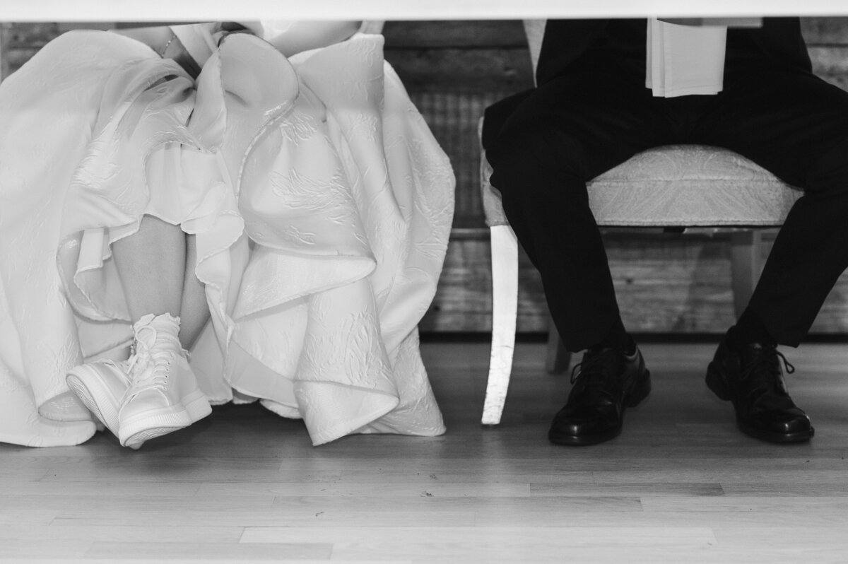bride and groom sitting shoes photo