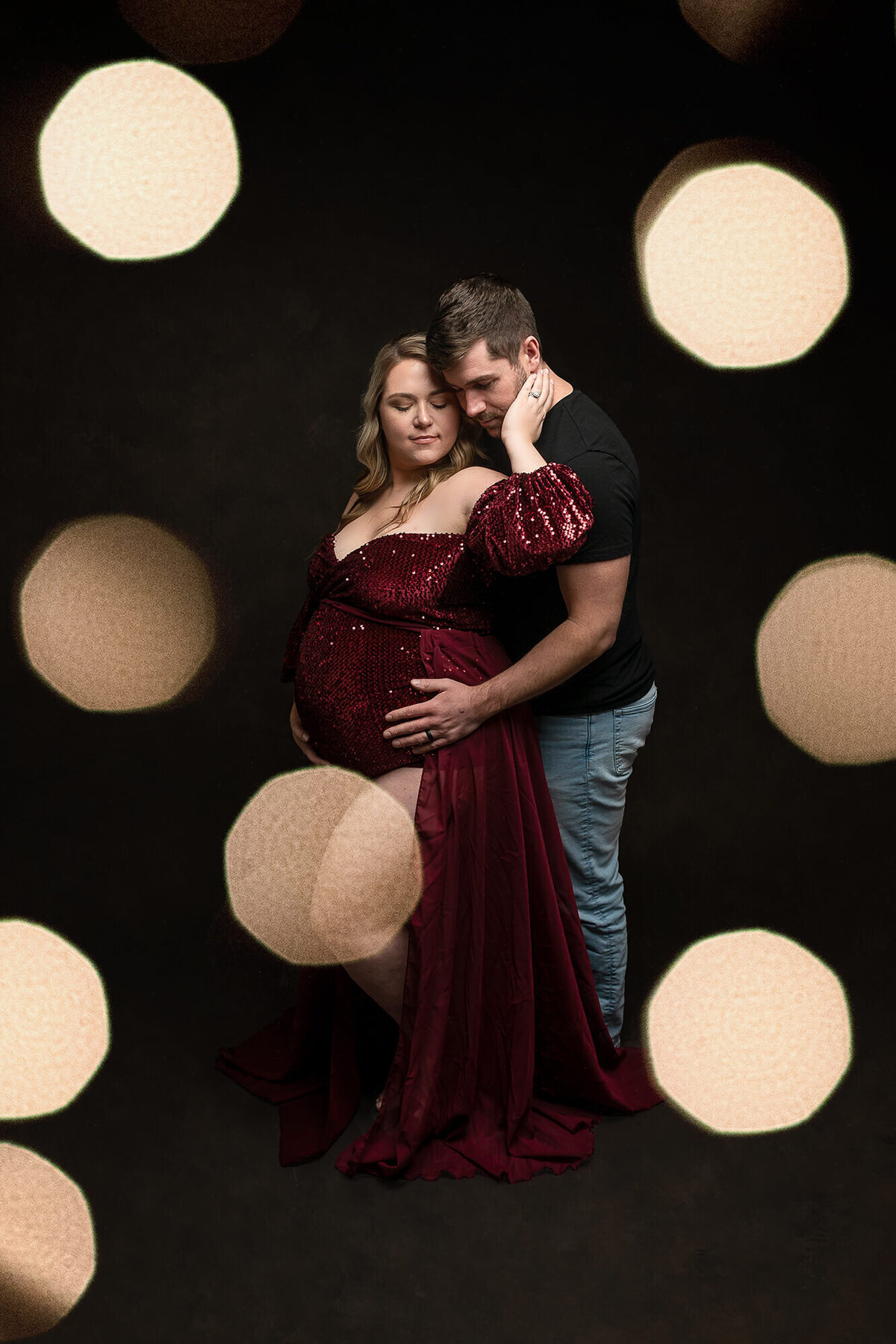 Beautiful bokeh lights framing this soon to be mom and dad.