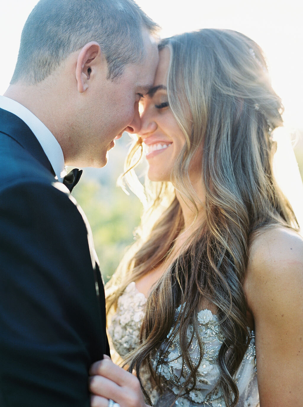 A breathtaking intimate moment between the bride and groom, bathed in golden sunlight. This romantic wedding portrait captures love, warmth, and the beauty of natural light photography.