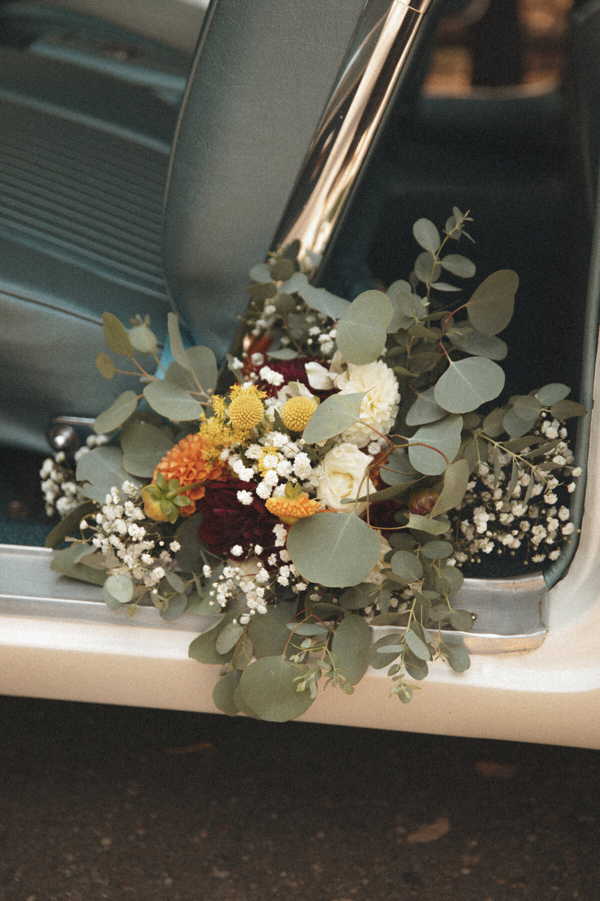 bridal bouquet in classic car