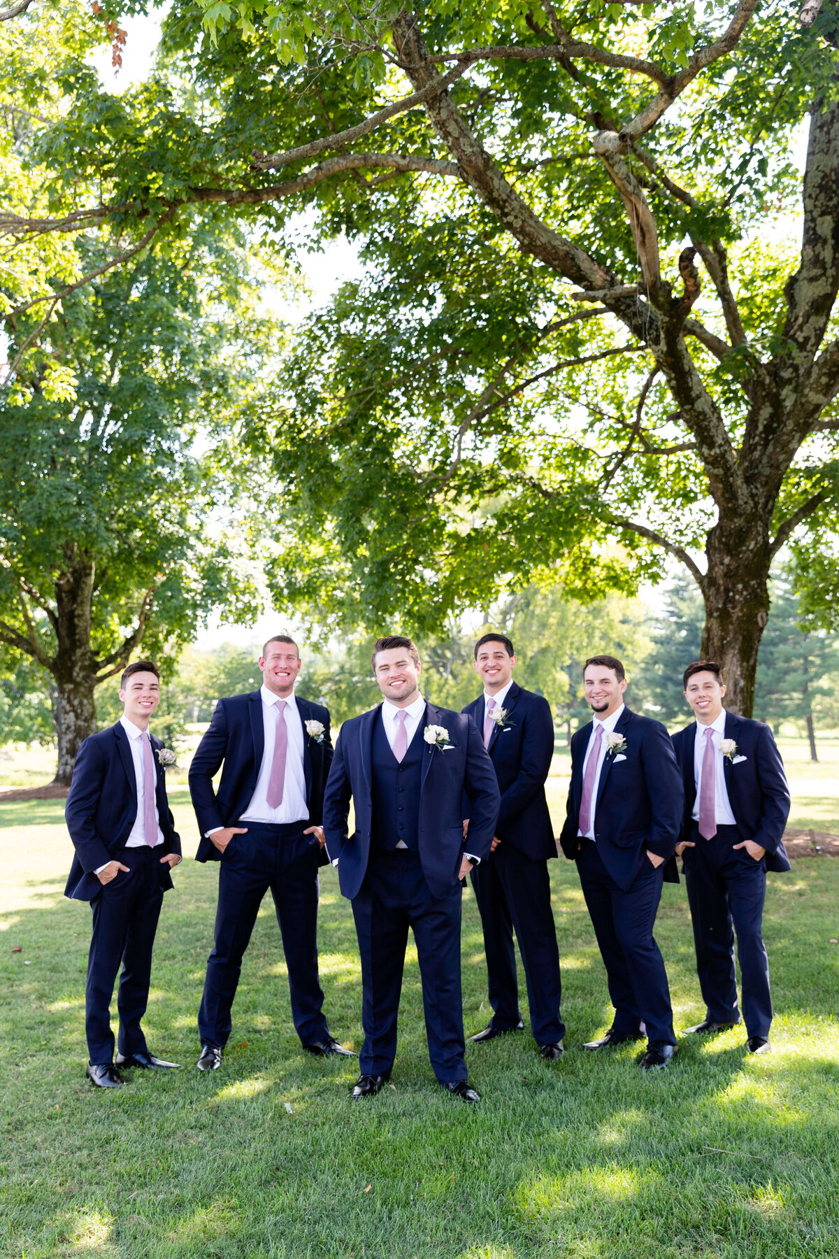 Groomsmen in black suits at wedding at Stones River Country Club