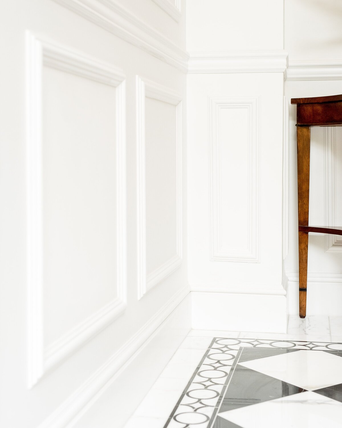 white-wall-paneling-marble-flooring-luxury-interior-comm-ave-min