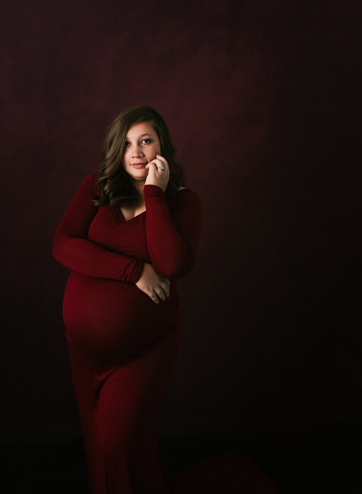 A pregnant mom, gorgeous in her red maternity gown.