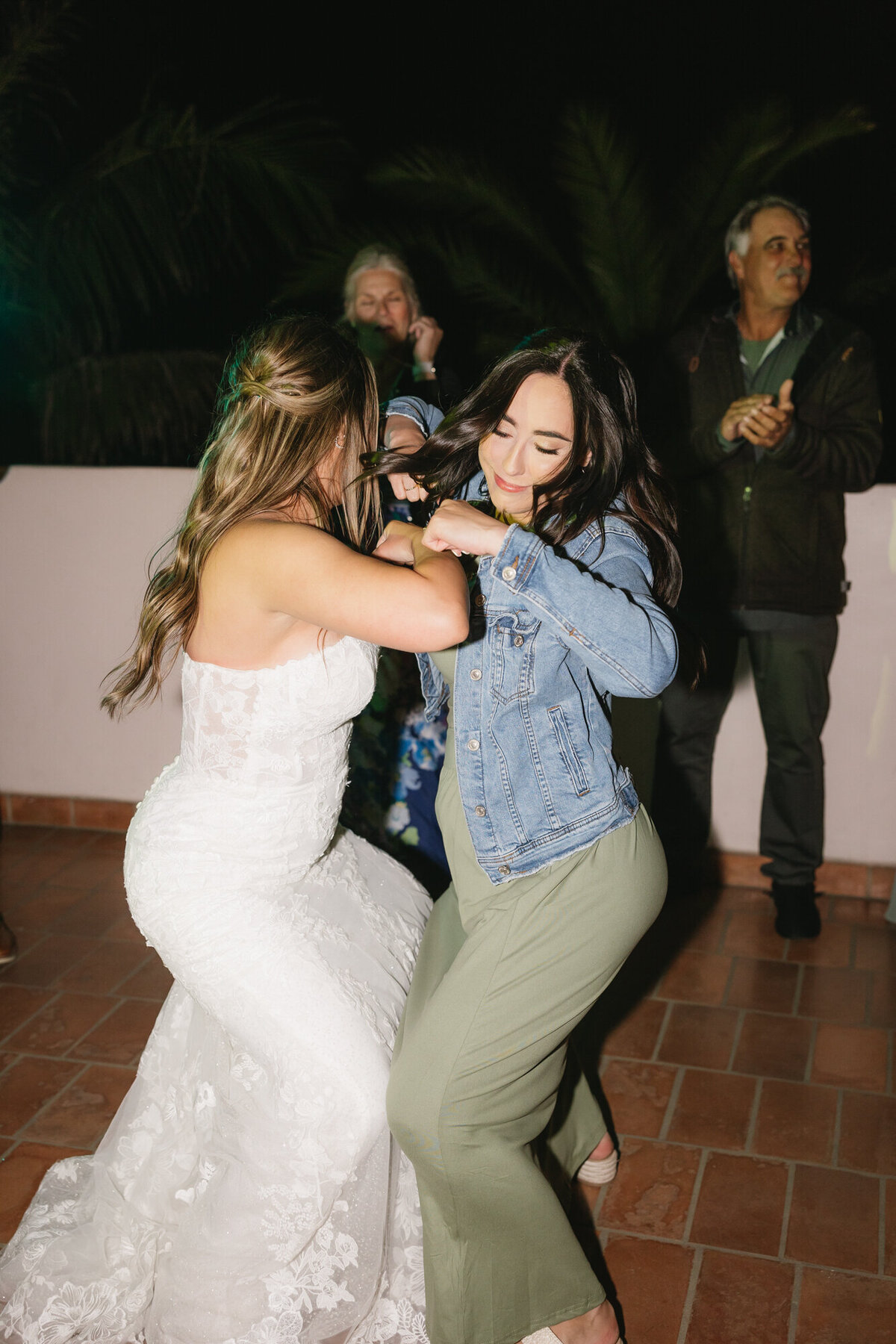 Bride dancing with maid of honor at wedding reception at Hilton Beachfront Resort Santa Barbara