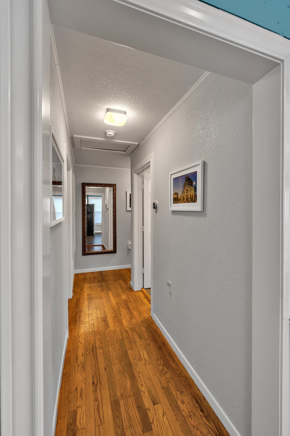 Beautiful hallway in this three-bedroom, two-bathroom vacation rental house with free Wifi, fully equipped kitchen, office space, and room for six in downtown Waco, TX.