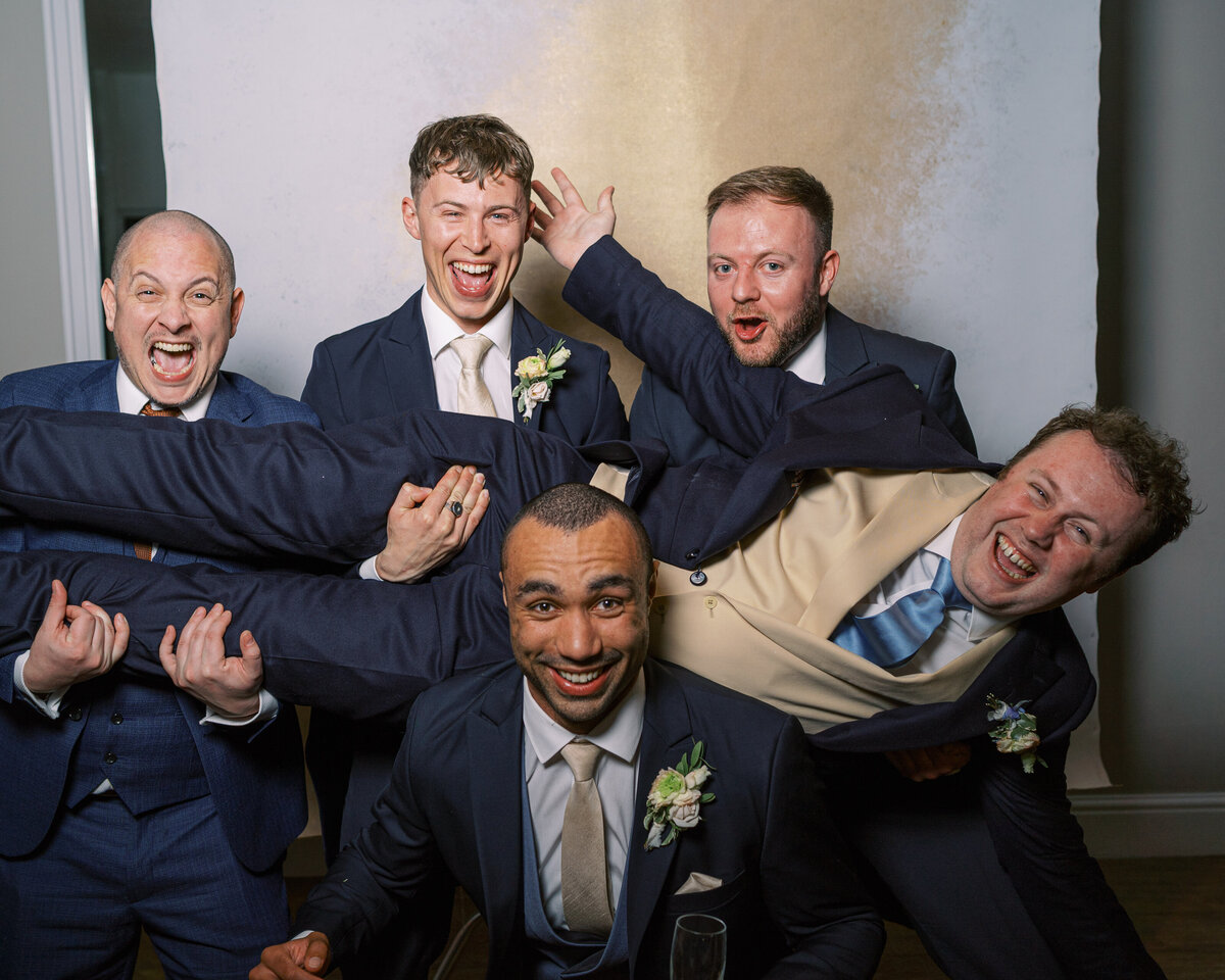 Groom and groomsmen in wedding portrait studio wedding photobooth