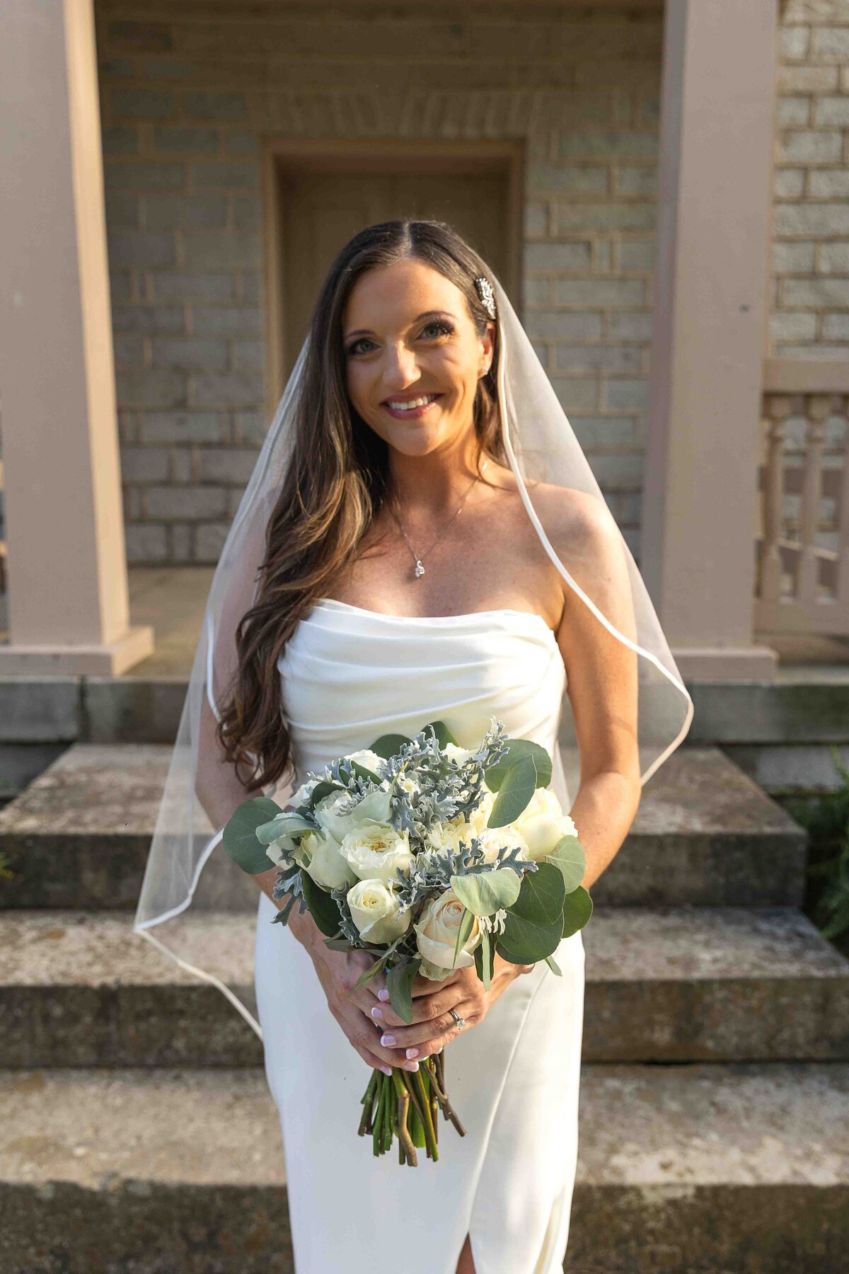 Bride holding wedding bouquet smiling