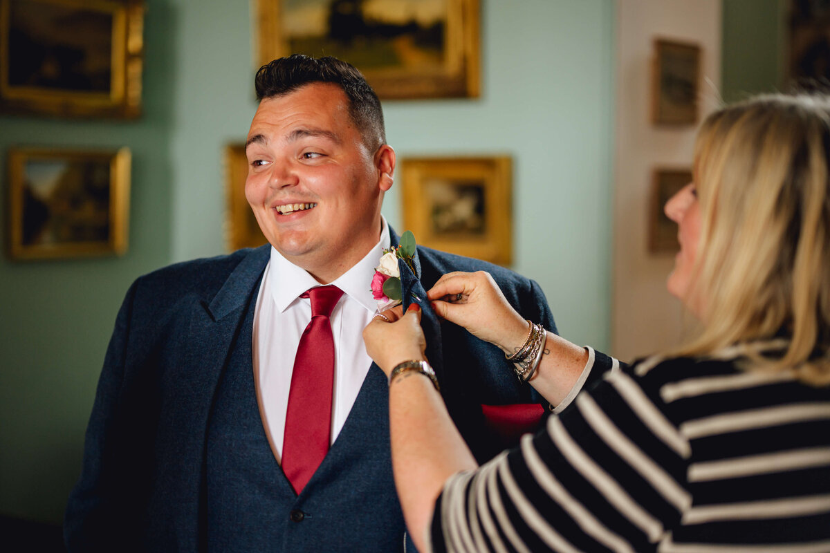 Jo attaching a buttonhole at Homme House