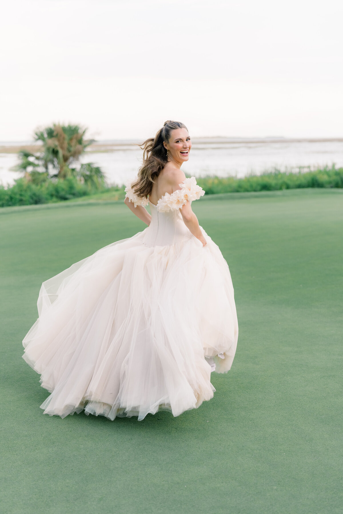 Runaway bride. Bride in blush wedding dress with flower sleeves.