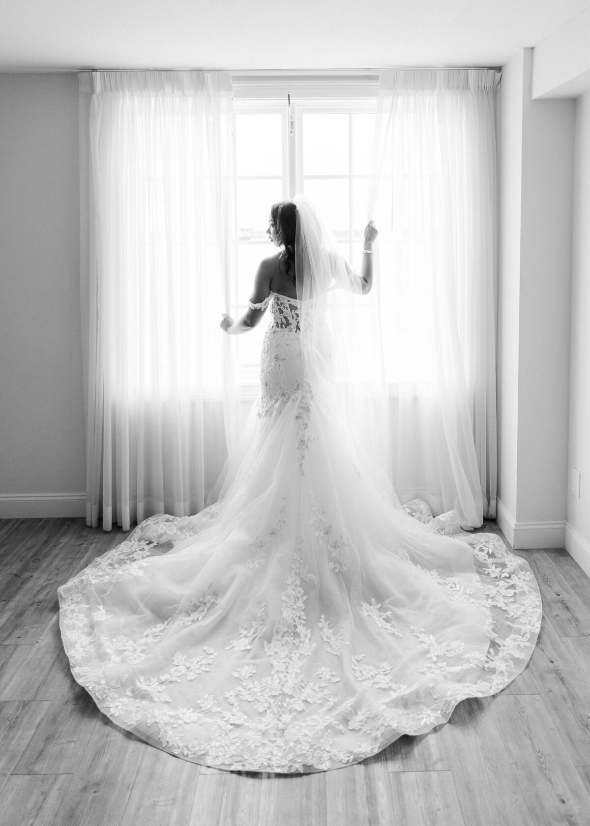 bride in window at Belle Mer longwood venue in Newport RI - Jamal & Lashana Photography (30)