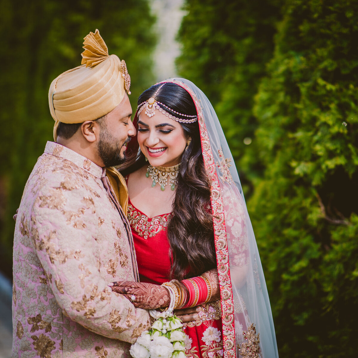 Bride and groom at their indian wedding sharing laughs during portraits at the surf club in ny