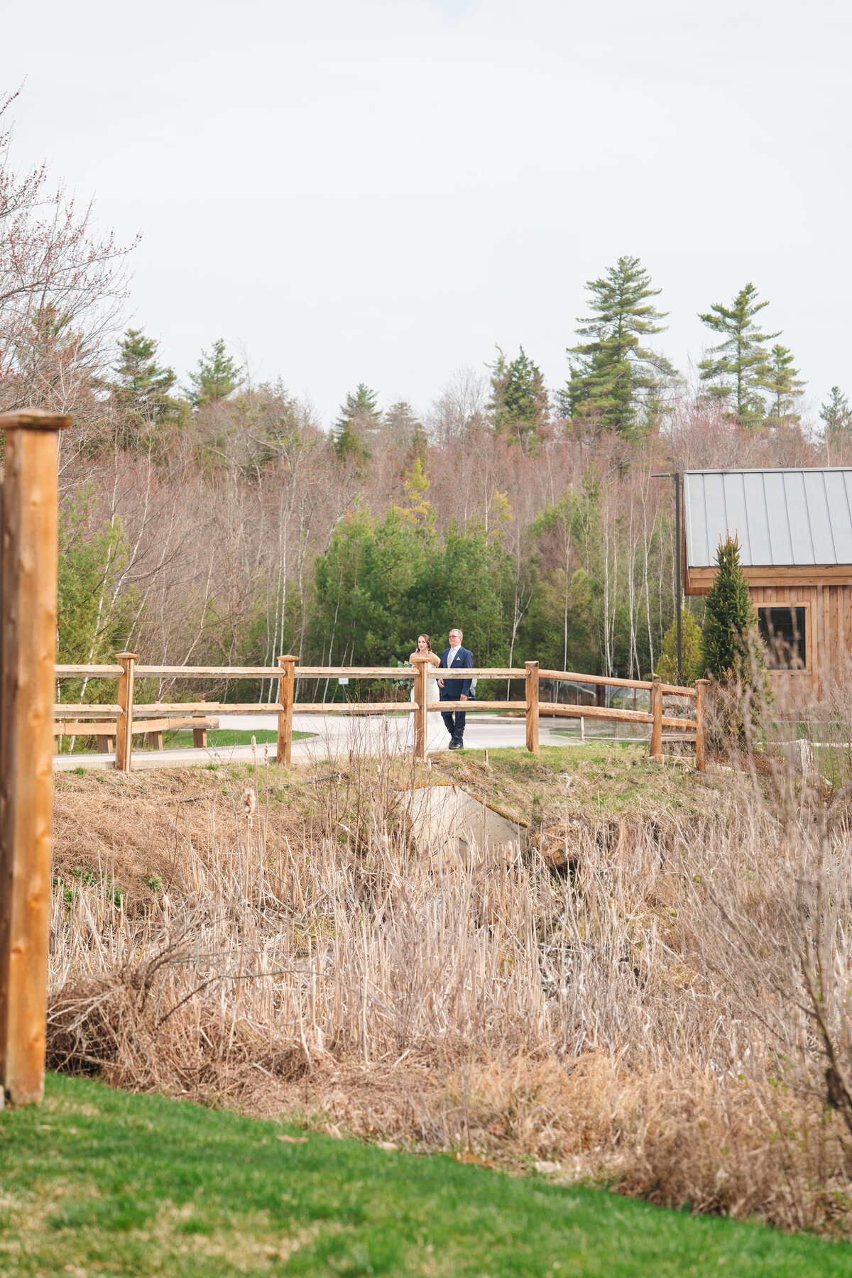 Couple exchanging vows under a floral arch in New England