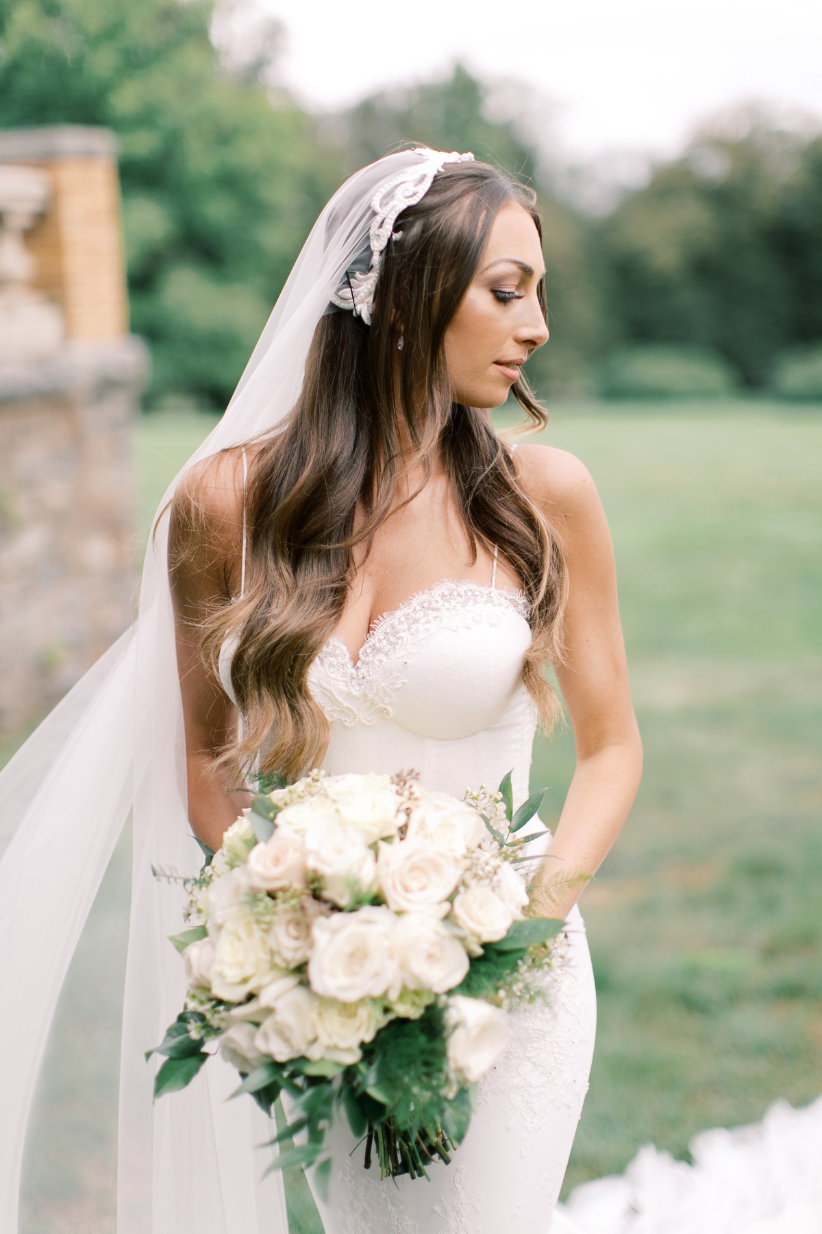 bride looking over shoulder wearing strapless lace wedding gown