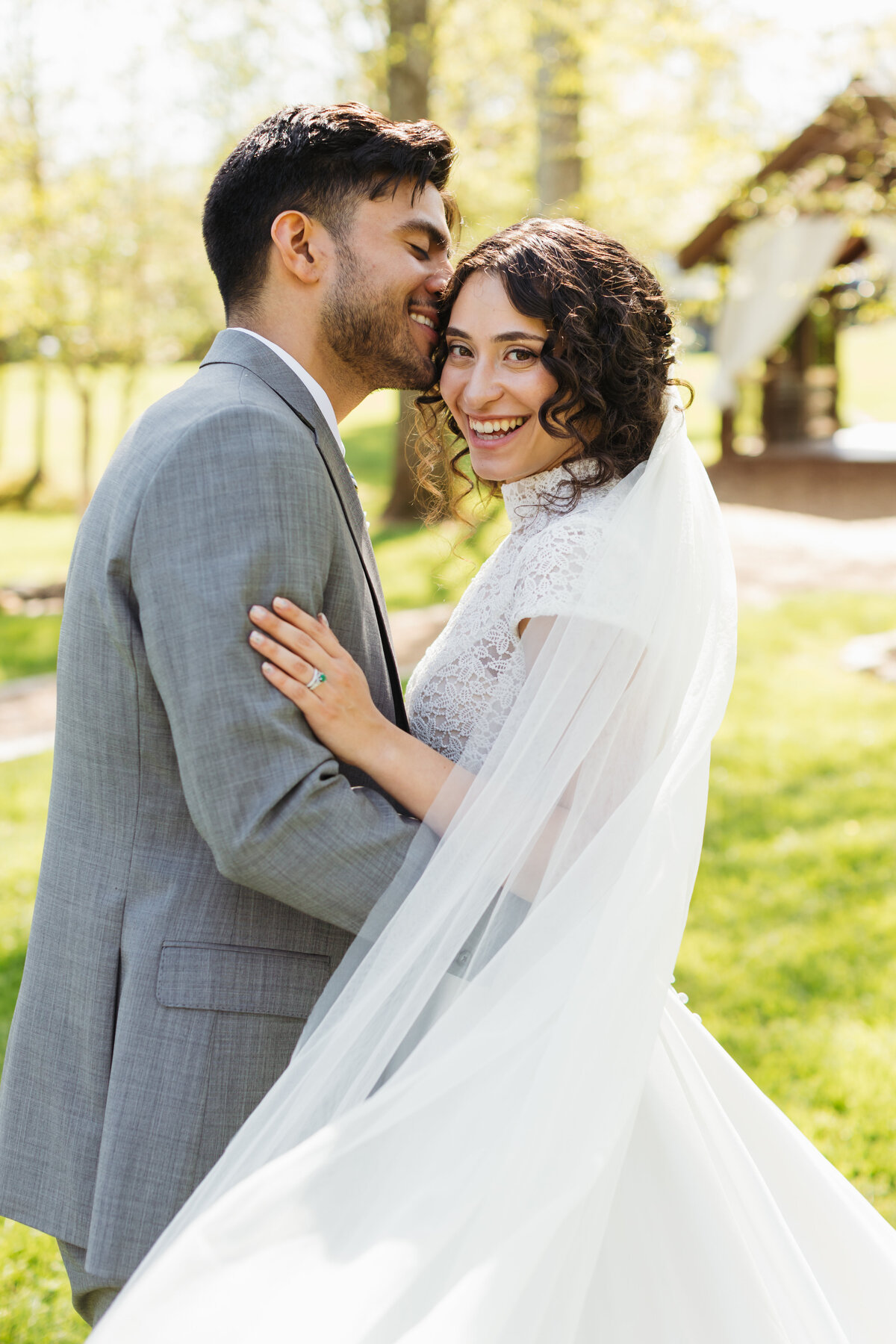 groom embracing his bride on their wedding day