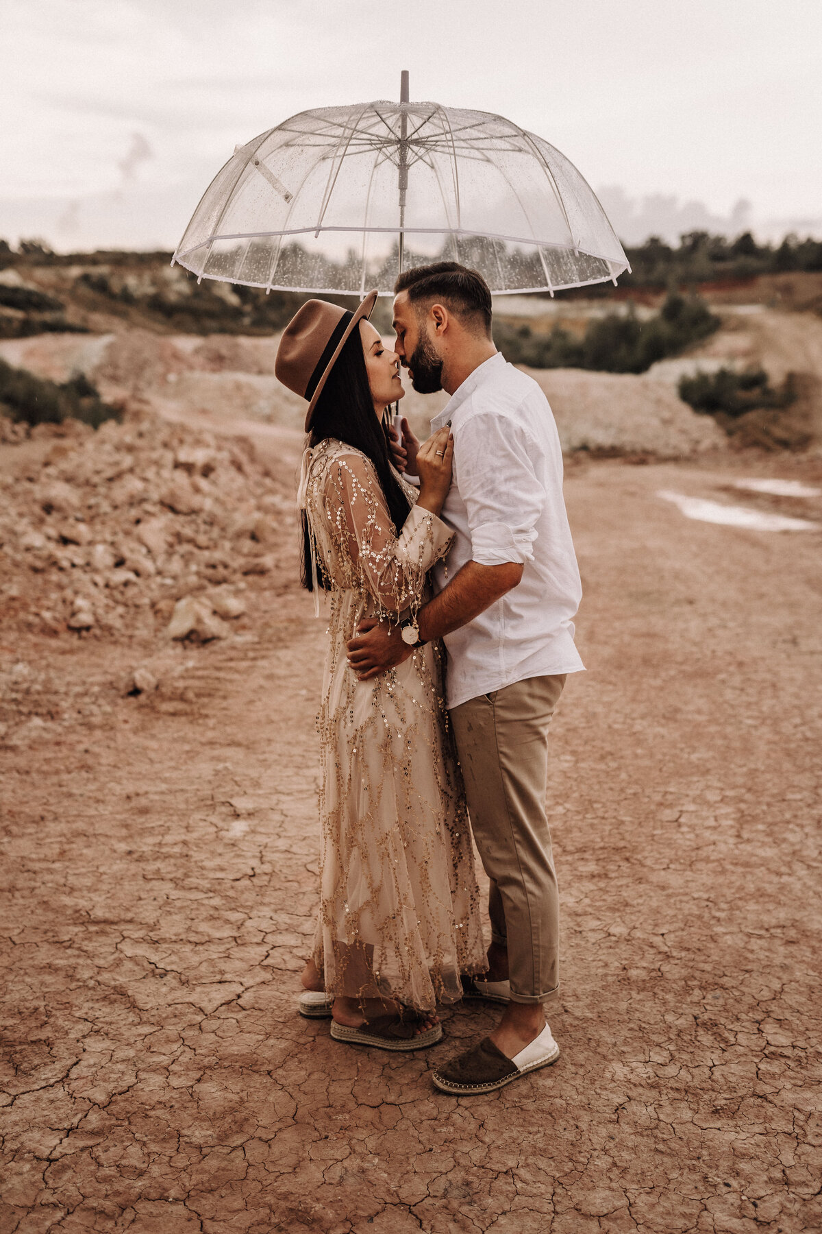 Liebespaar unter einem Regenschirm in einem Steinbruch