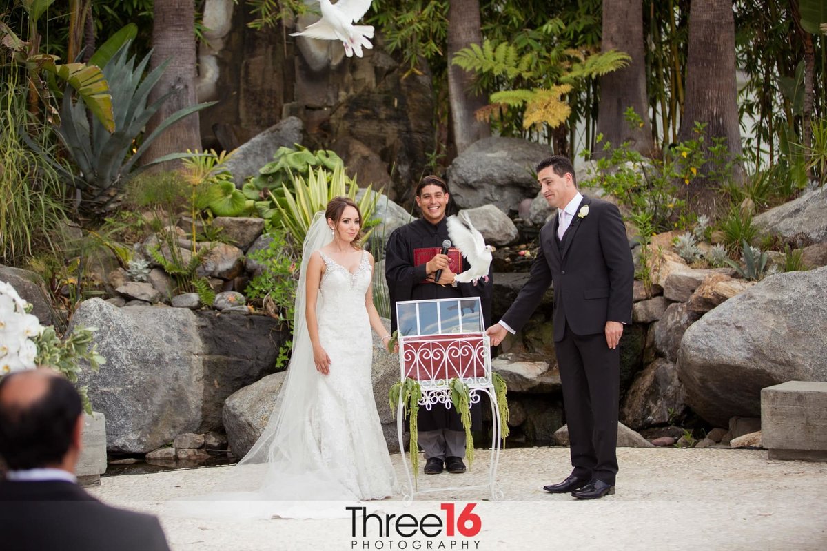 Bride and Groom release a white dove during the wedding ceremony