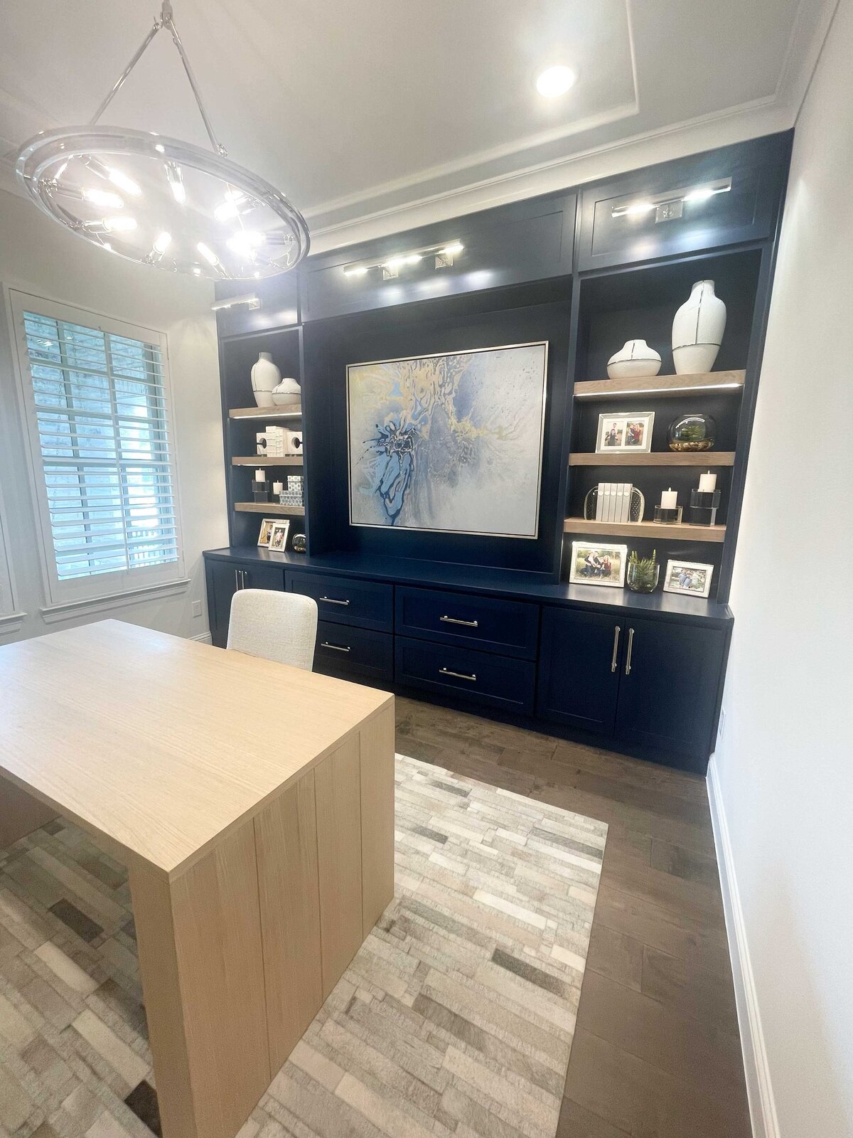 Interior design for a custom home featuring a blue-decorated home office, complete with elegant furnishings, a stylish desk, and organized shelving for a productive and sophisticated workspace.
