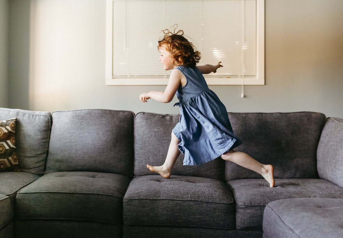 Bobby-Dazzler-family-photographer-girl-jumping-on-the-couch