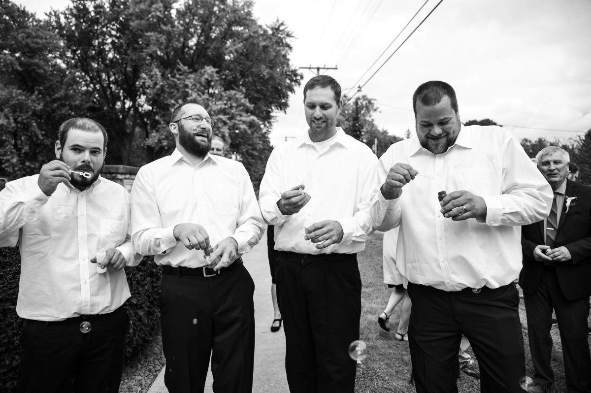 group shot of groomsman with bubble blowers