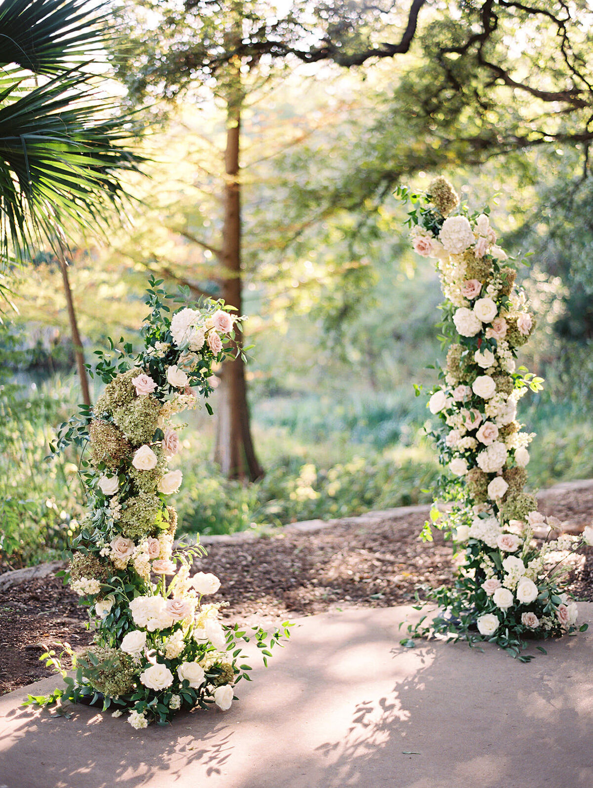 An asymmetrical floral installation for a wedding ceremony at Laguna Gloria