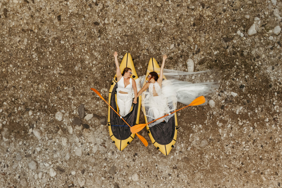 Aerial view of brides in yellow packraft in Soča Valley river elopement