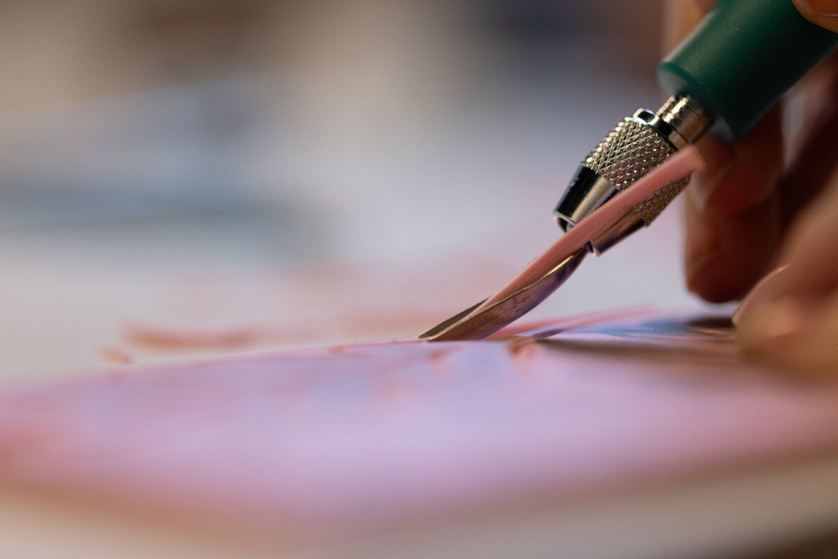 carving-a-design-into-linoleum-printmaking