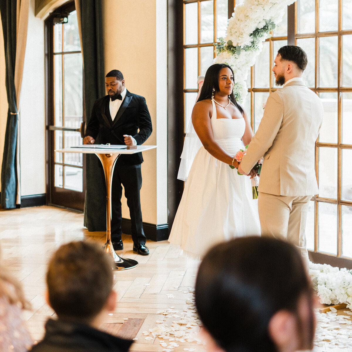 bride and groom holding hands at their ceremony at the stirling club in las vegas