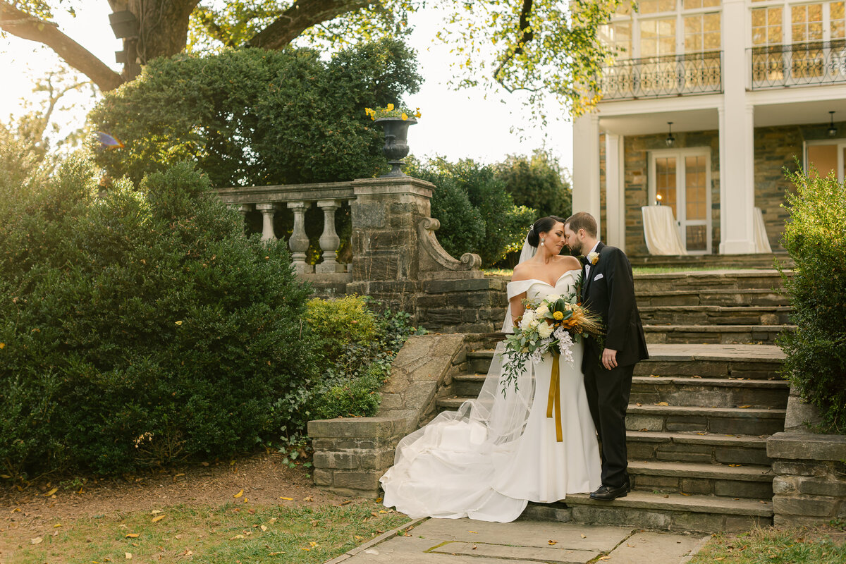 Wedding Photographer, a bride and groom stand together on an estate porch